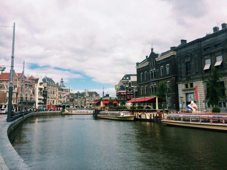 A view along the Rokin canal in Amsterdam, with tour boats moored next to the Allard Pierson Museum.