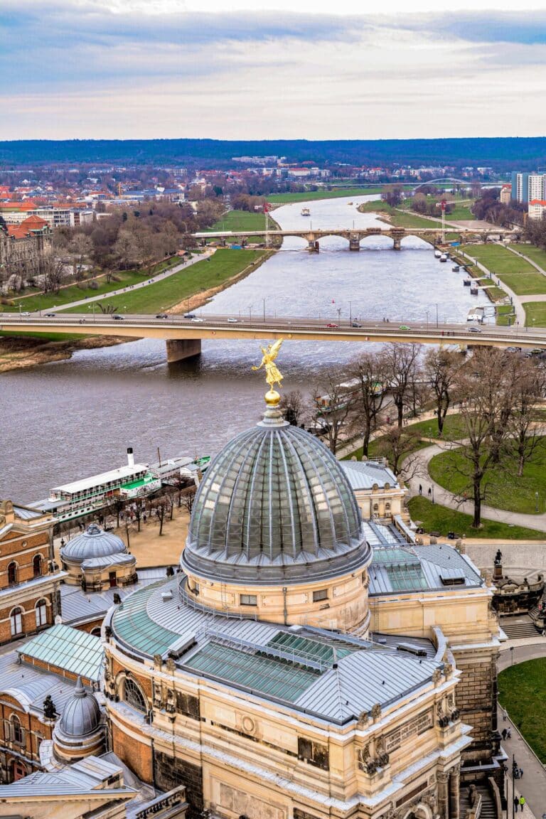 Aerial view looking over the glass dome of the Dresden Academy of Fine Arts to the Elbe River.