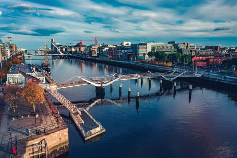 An elevated view over the River Liffey in Dublin showing the Seán O'Casey Bridge in the foreground.