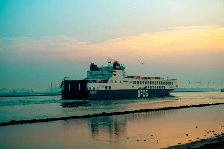The large DFDS ferry Scandia Seaways sailing on the water in Hoek van Holland during a colorful sunset.