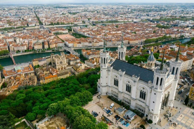 An aerial view of Lyon from Fourvière hill, with the Basilica of Notre-Dame de Fourvière overlooking the city.