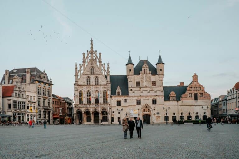 The historic City Hall and surrounding buildings on the cobblestone Grote Markt square in Mechelen, Belgium.