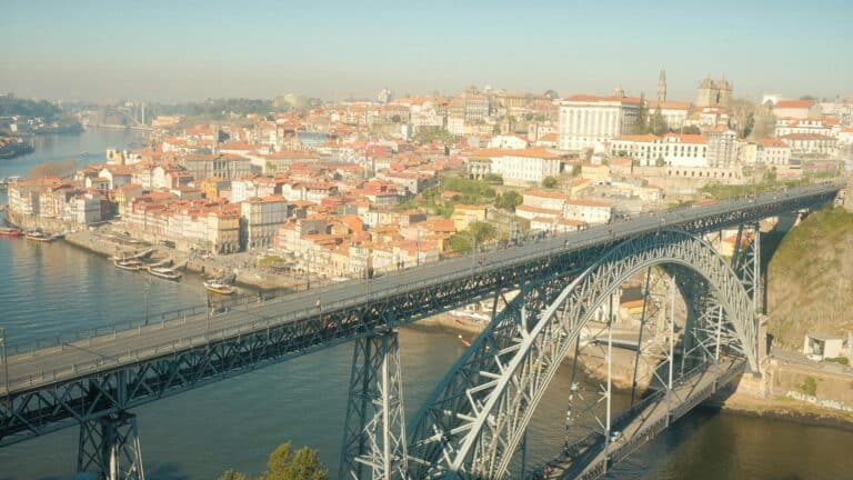 A scenic view of the Dom Luís I Bridge spanning the Douro River in Porto, Portugal.
