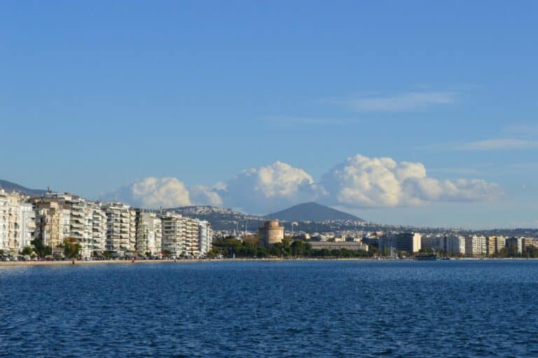 The Thessaloniki waterfront seen from the sea, with the historic White Tower and city buildings.