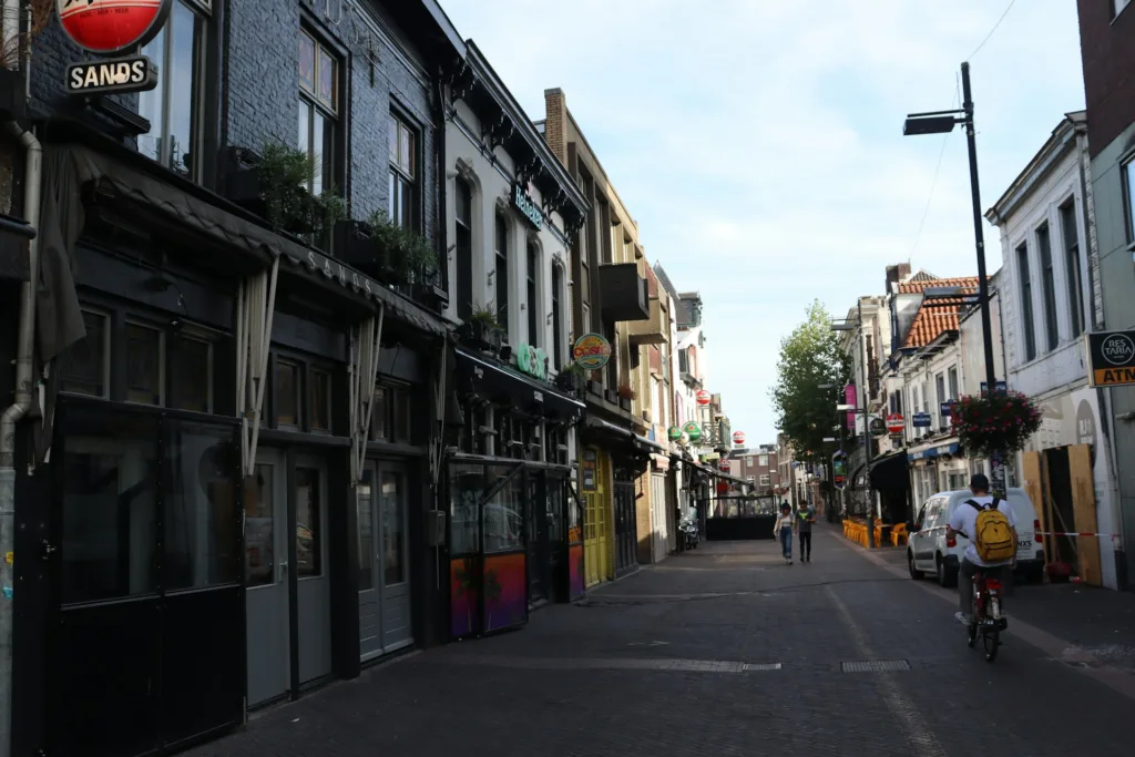 City Game Eindhoven city center, lined with cozy cafés and vibrant shops, capturing the lively yet relaxed atmosphere of the city