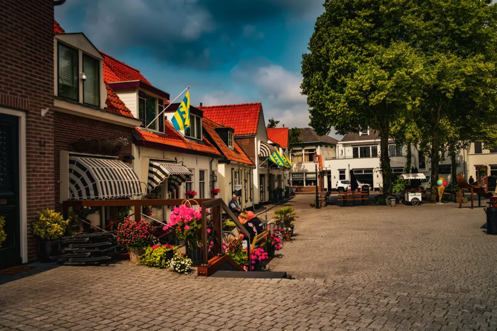 City Game Harderwijk a cobblestone street lined with houses and flowers