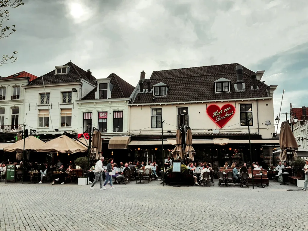 City Game Den Bosch vibrant terrace scene under the iconic 'Hart van Brabant' sign