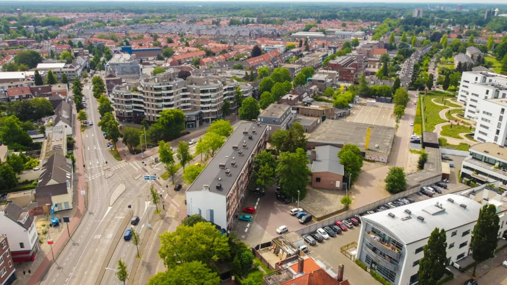 City Game Eindhoven aerial view of a vibrant neighborhood in Eindhoven, showcasing modern architecture, lush greenery, and well-organized streets that highlight the city's urban charm and design.