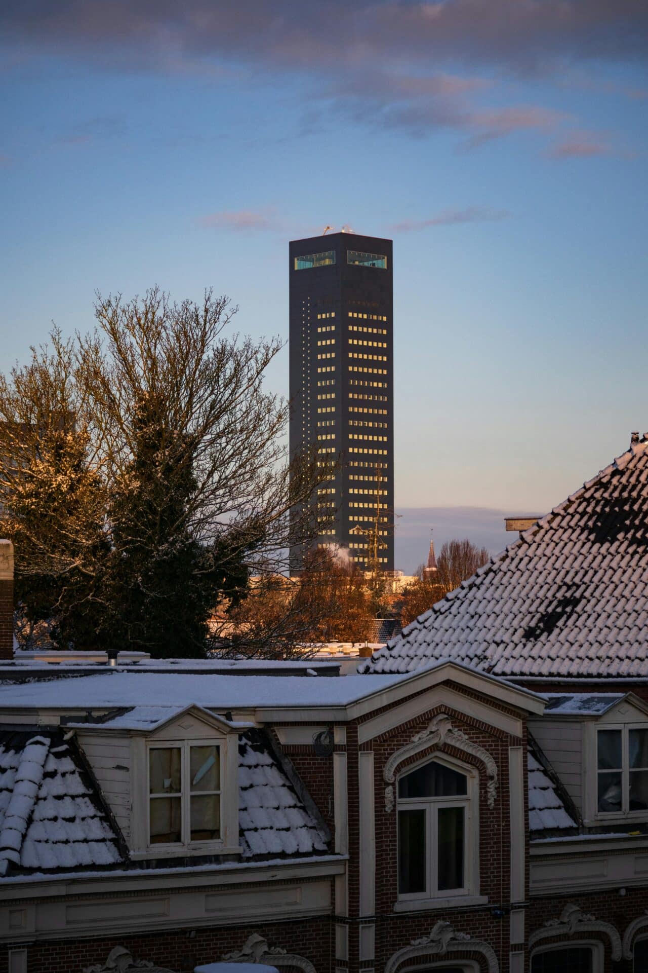 Achmea Tower Over Snowy Rooftops in Leeuwarden